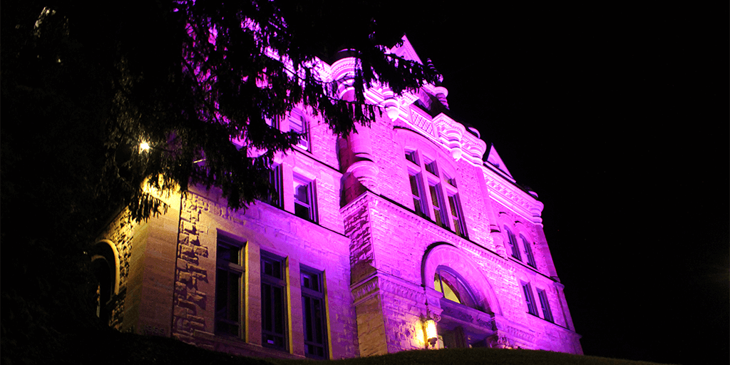 the east face of schuylkill county courthouse lit up purple in honor of national recovery month