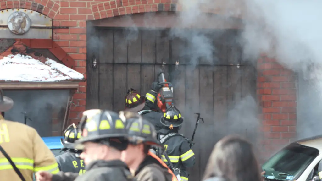 A chainsaw is used to get through the former garage bay doors on the old firehouse that's been converted to a residence.