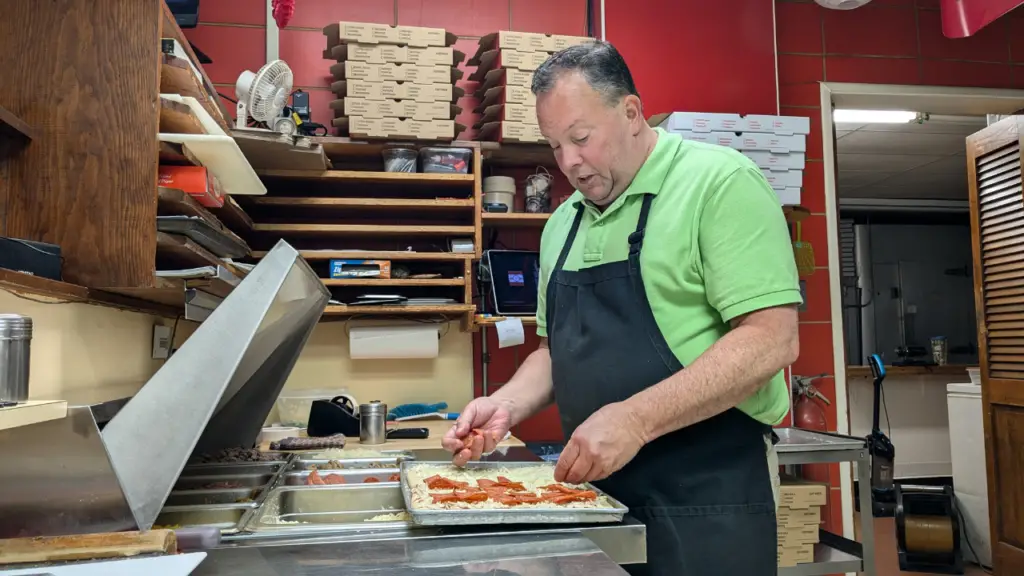 Scott Kline prepares a fresh pie at Pottsville Pizzeria in Mount Carbon.