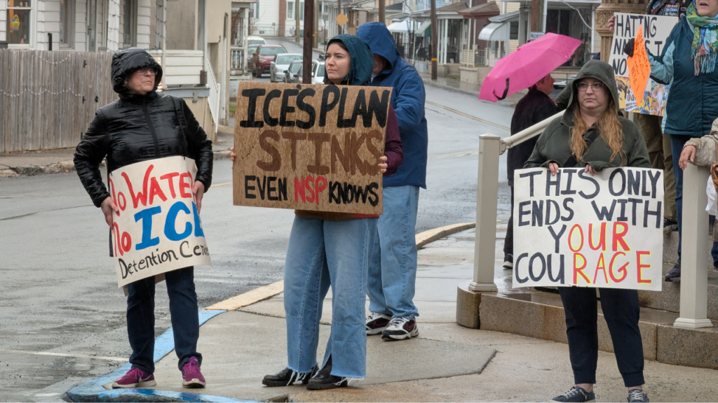 Alyssa Hatter, of Tremont, holds a sign expressing her opposition to the proposed ICE detention center in Tremont Township.