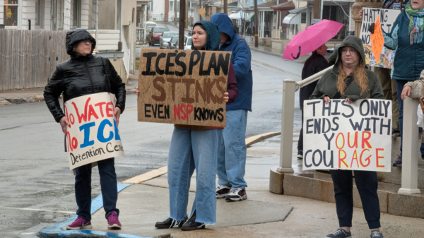 Alyssa Hatter, of Tremont, holds a sign expressing her opposition to the proposed ICE detention center in Tremont Township.